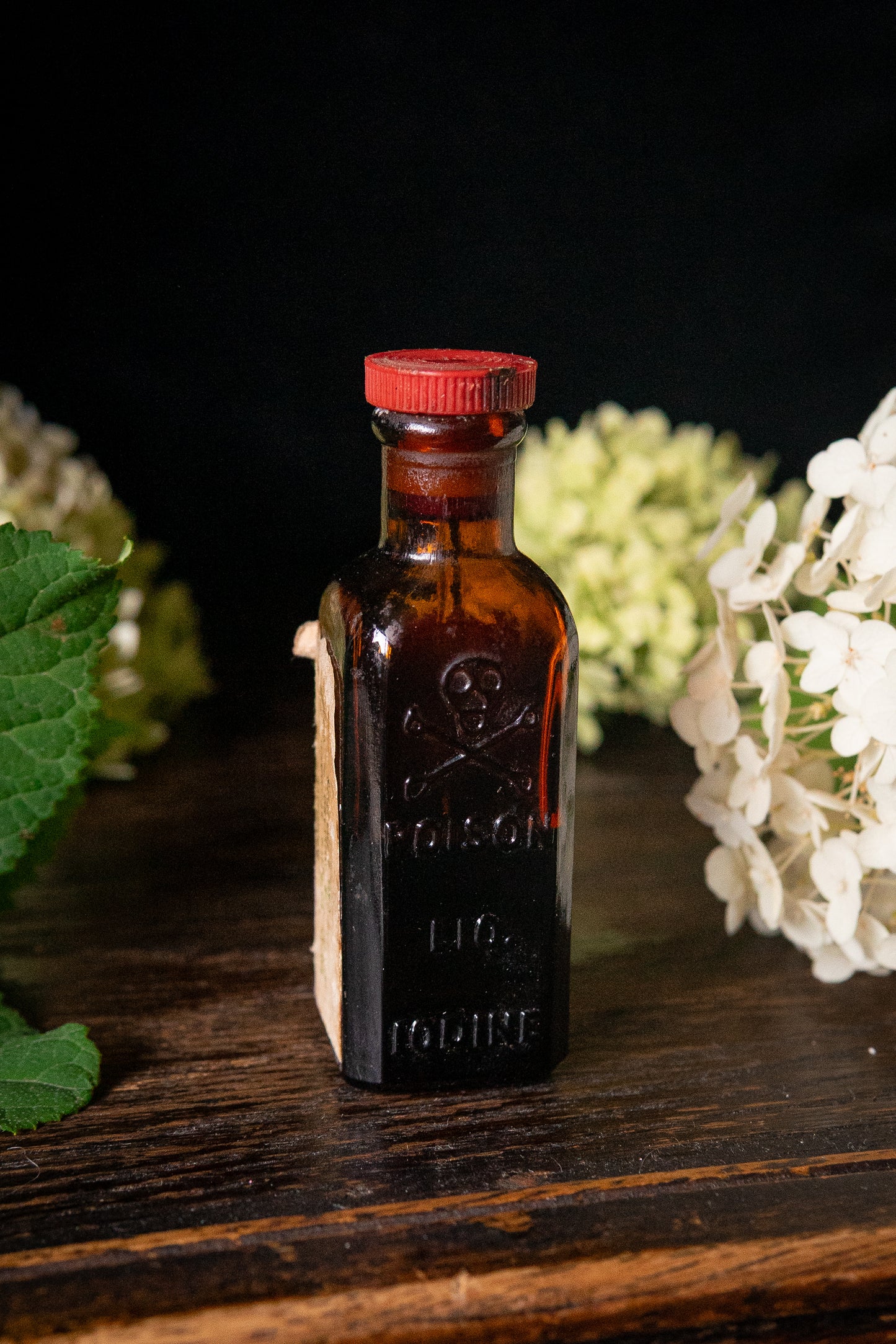 Vintage poison iodine bottle with skull and crossbones